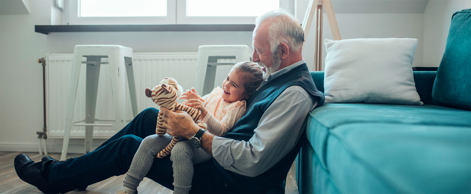 Man and grandchild playing in living room