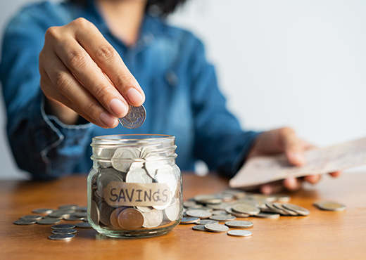 Woman putting coins into jar